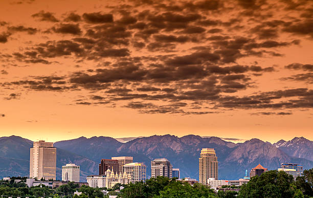 Skyline of Utah city with clouds Morning orange sky over Salt lake city utah mormonism photos stock pictures, royalty-free photos & images