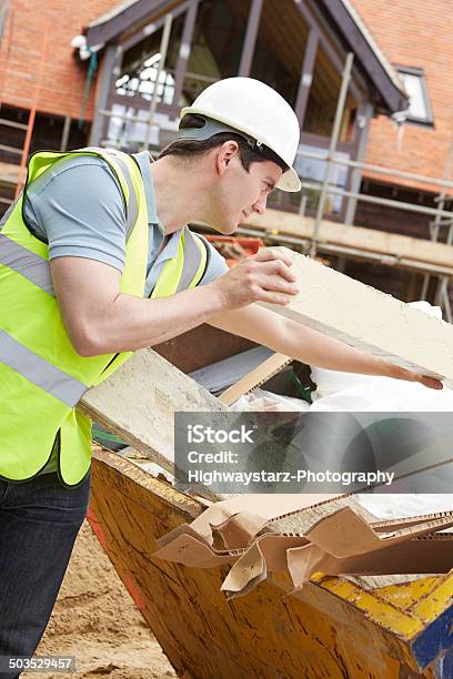 Builder Putting Waste Into Rubbish Skip Stock Photo - Download Image Now - Construction Industry, House, Industrial Garbage Bin