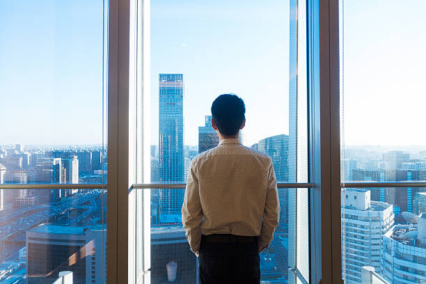 istock Businessman looking cityscape through the office window 503531780