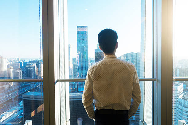 istock Businessman looking cityscape through the office window 503531930