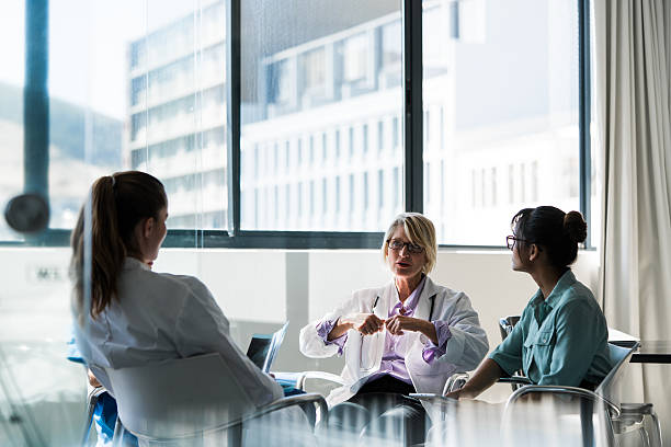 Doctor discussing with team in hospital