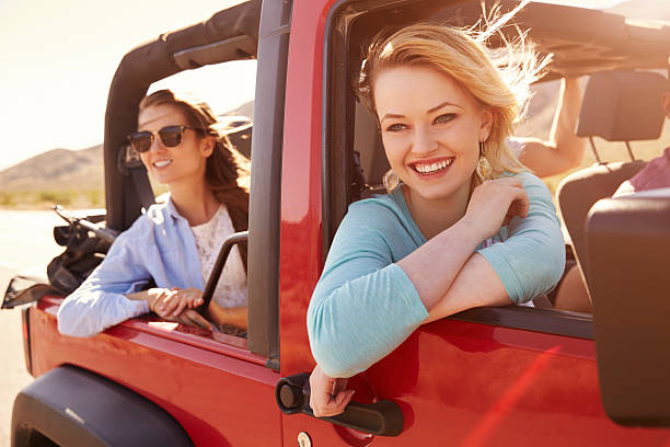 istock Two Female Passengers On Road Trip In Convertible Car 503533736
