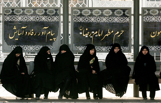 Mashhad,Iran - February 14,2008 : Mashhad is the second largest city in Iran.Mashhad is a holy city for Shi'ite Muslims.Women waiting at the bus stop.