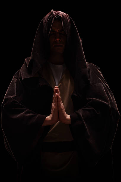 moine avec une capuche sur sa tête praying - brain wash photos et images de collection