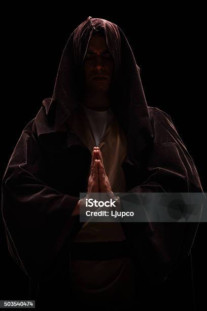 Monk With A Hood On His Head Praying Stock Photo - Download Image Now - Cult, Leadership, Ceremonial Robe