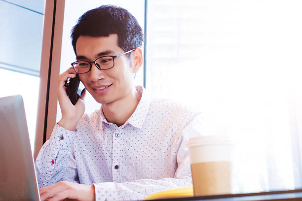 istock Young businessman calling on mobile phone with laptop 503541036