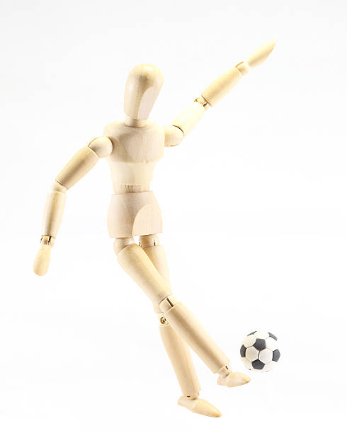 istock Wooden puppet playing football 503541452