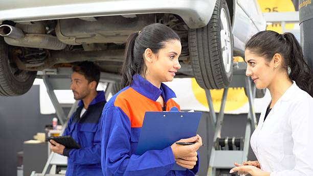 istock Two women gossiping in the garage 503541728