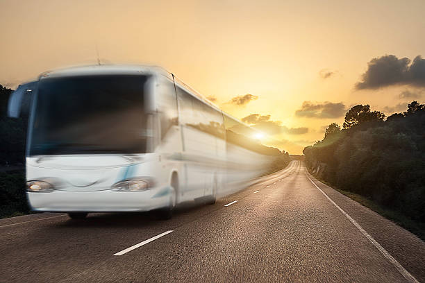 istock White bus on the sunny road, motion blurred 503542186
