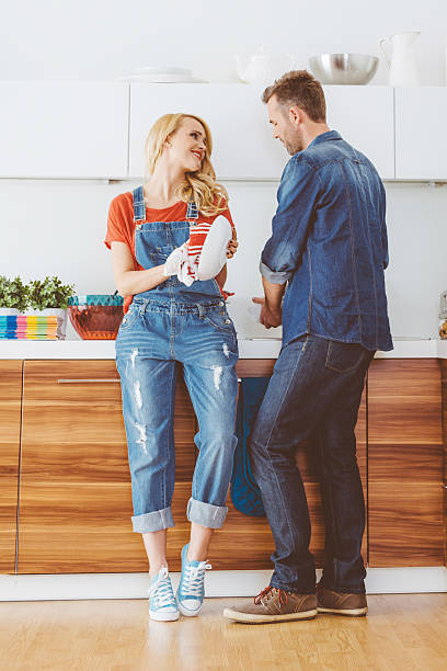 istock Happy couple cleaning dishes in the kitchen 503544152