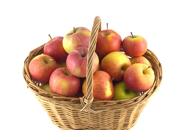 istock Ripe apples in wicker basket isolated on white 503545738