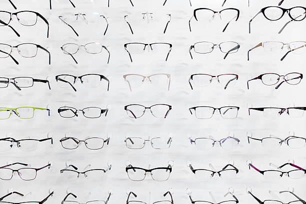 Selection of eyeglasses on a white wall