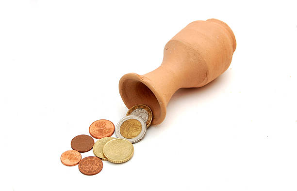 istock coins pouring out from the clay vase 503546264