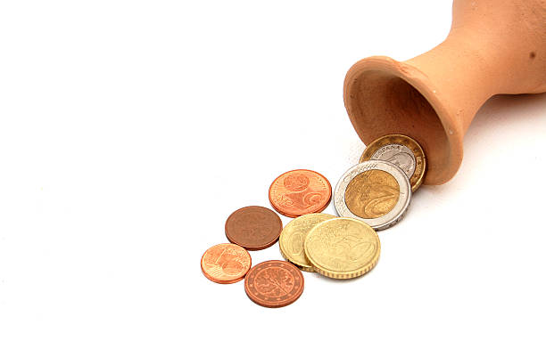 istock coins pouring out from the clay vase 503546276