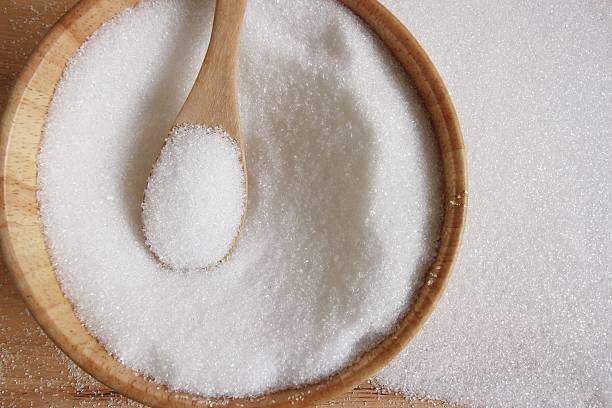istock white sugar in wood spoon 503554394