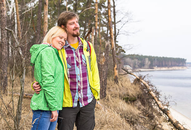 istock Young loving couple enjoy near lake in spring forest 503554632