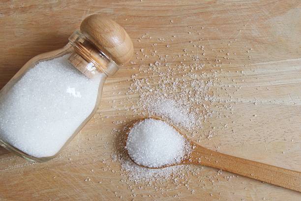 istock white sugar in wood spoon 503555290