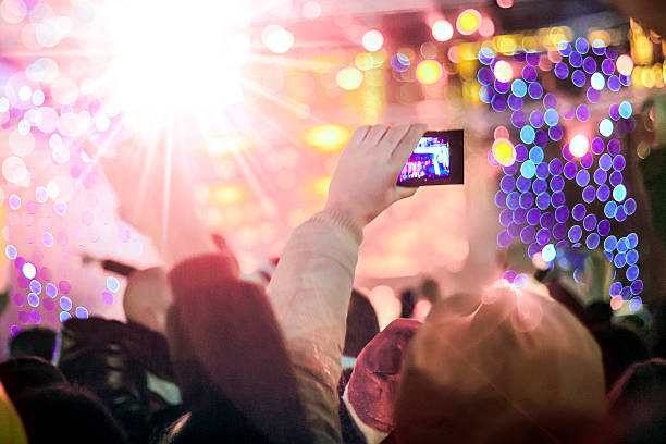 istock Fan filming concert with his cell phone 503556838