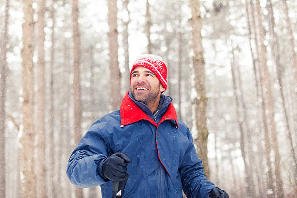 Young man walking in a winter wood.
