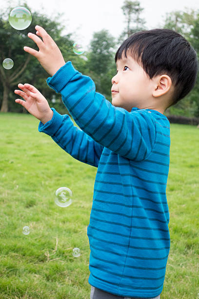 istock Cute asian boy playing with soup bubbles 503559210