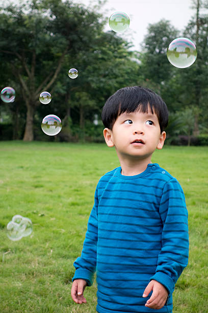 istock Cute asian boy playing with soup bubbles 503559534