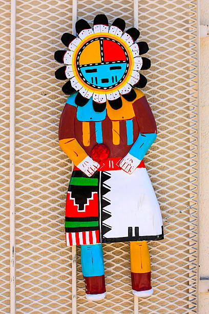 Two-dimensional Native American Hopi kachina doll Albuquerque, NM, USA - June 17, 2015: Hopi hand crafted metal wall mounted kachina doll on sale outside a store in Albuquerque, New Mexico kachina doll stock pictures, royalty-free photos & images