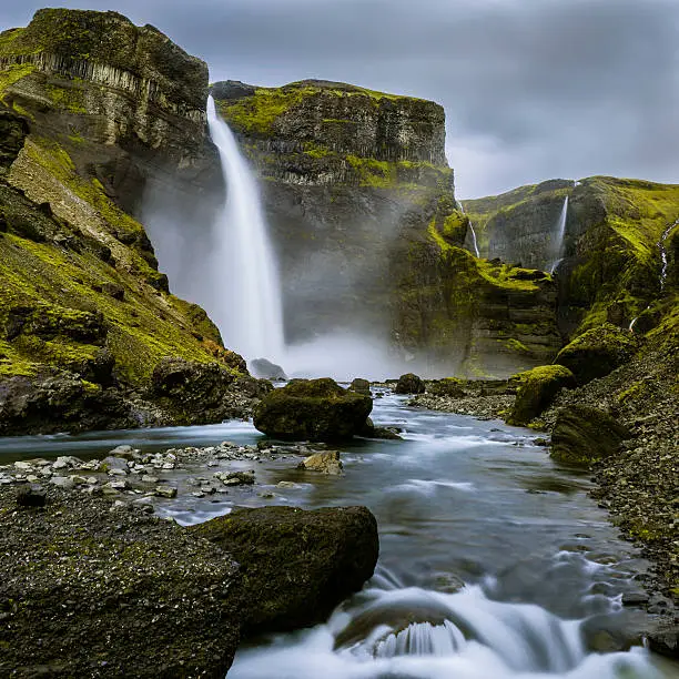The Haifoss waterfall in Iceland from below down in the canyon of the Fossa river. Long exposure image with smooth water.