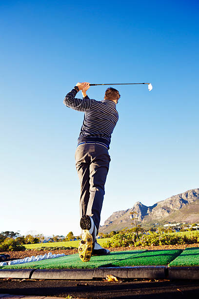 istock Practising golf at the driving range, young man hitting ball 503563133