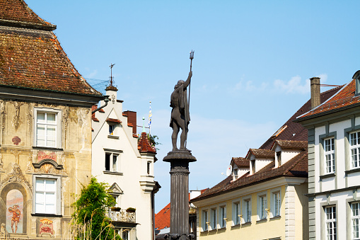 Lindau, Germany - July 11, 2015: Summertime shot of square Marktplatz on Lindau island. In center is column with statue of fountain.