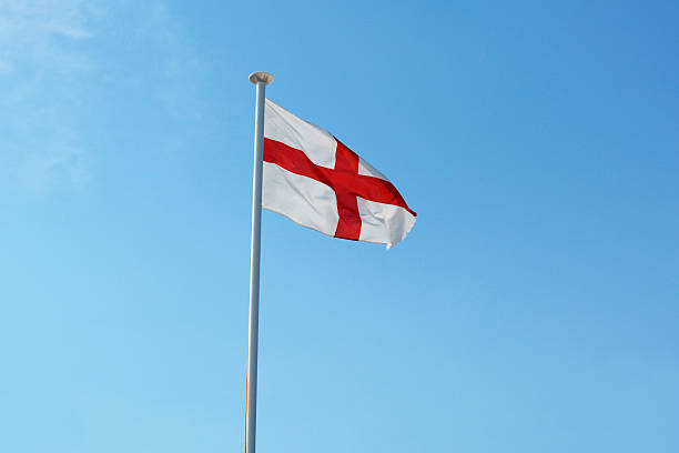 istock The English flag flies against a blue sky 503564407