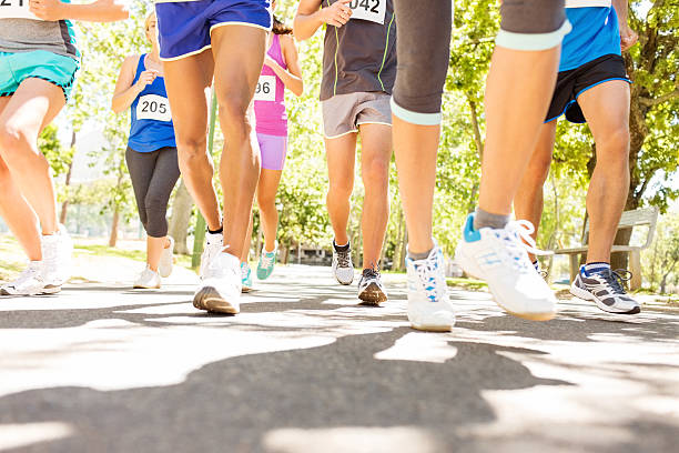 istock Low Section Of Marathon Runners Competing At Park 503565231