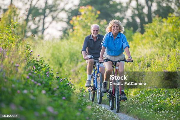 Senior Couple Biking Stock Photo - Download Image Now - Cycling, Senior Couple, 50-59 Years