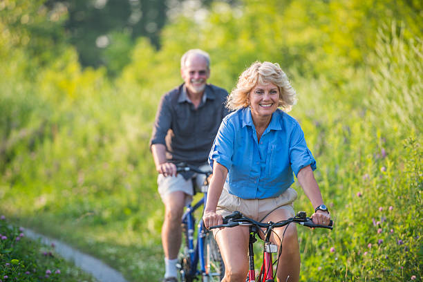 istock Senior couple biking 503566523