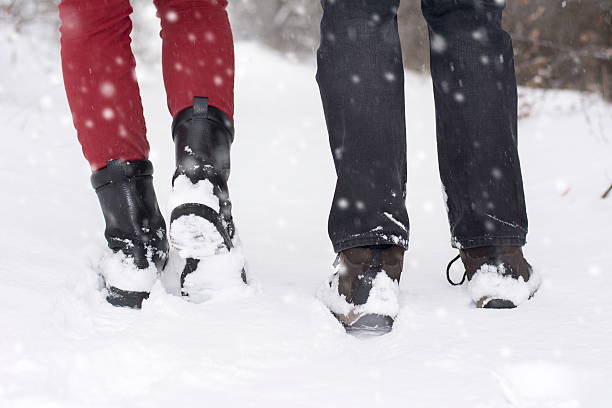 istock Couple in love outdoors walking on snow 503566644