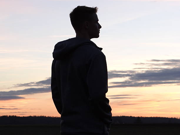 Silhouette of a teenager stock photo