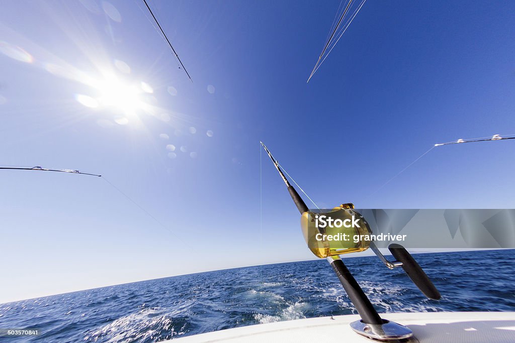 Ocean Fishing Reel Two big fishing reels on a boat in the ocean.  These reels are used to catch big game fish such as Mahi-mahi, dorado, tuna, sailfish, swordfish sharks and marlin.  They are used in tropical and cold water oceans. Big Game Fishing Stock Photo