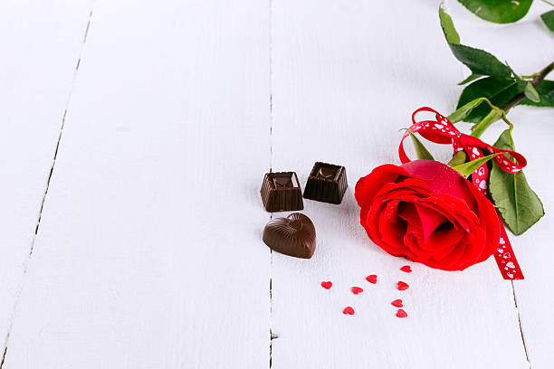 istock Red rose, chocolates on a white wooden background 503583446