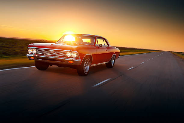 rétro voiture chevrolet malibu années 1960 voiture de vitesse sur route au coucher du soleil - 1960’s photos et images de collection