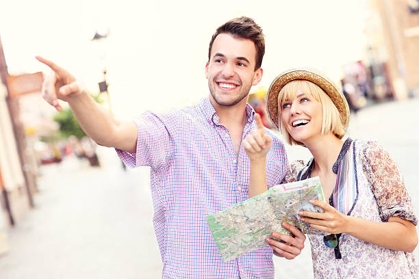 istock Happy tourists sightseeing the city with a map 503586566