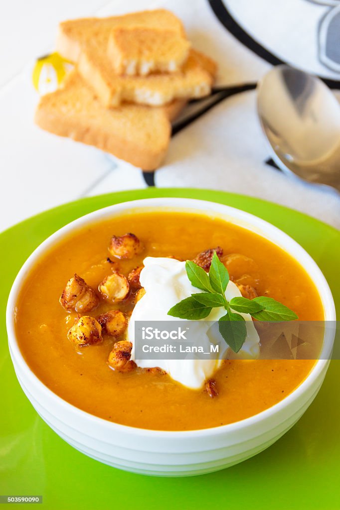 Carrot soup with cream and chickpeas Carrot soup with baked chickpeas Basil Stock Photo