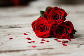 Roses and little hearts on wooden background