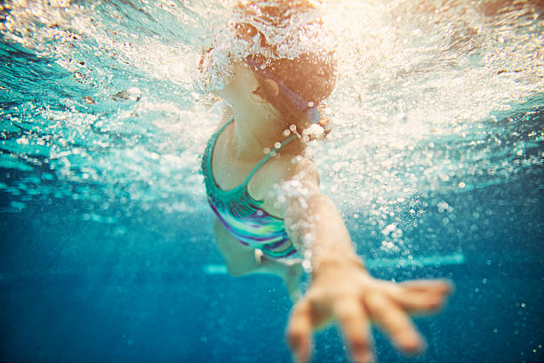 istock Little girl swimming crawl 503590916