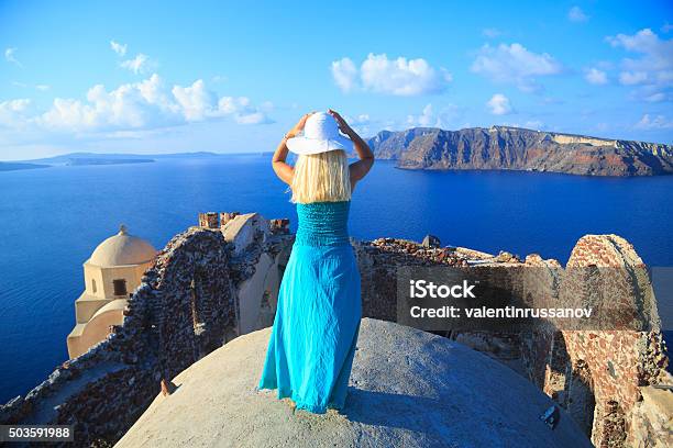 Woman With Turquoise Dress In Santorini Greece Stock Photo - Download Image Now - Fun, Rear View, 20-24 Years