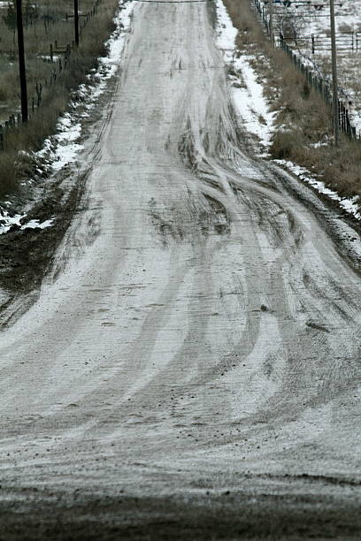 istock Wet, snowy dirt road 503592522