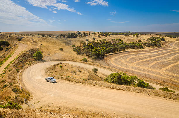 istock Car driving up hill on curvy rural dirt road 503593458