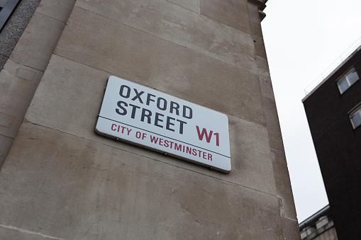 London, UK: A sign for Oxford Street in central London. Oxford Street is a popular retail street with many flagship stores.