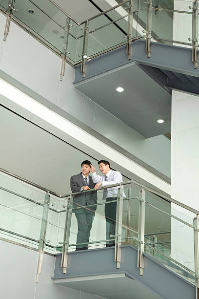 istock Businessmen Discussing and Pointing on Stairway 503597495