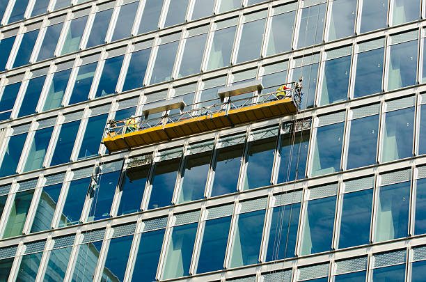 istock office window cleaners on a crane 503598205