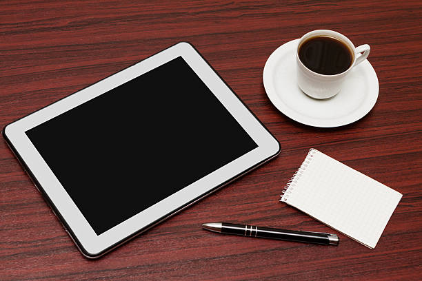 istock empty tablet and a cup of coffee in office 503599127