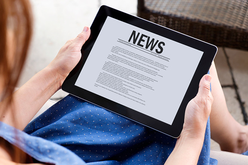 woman reading news with tablet Pc